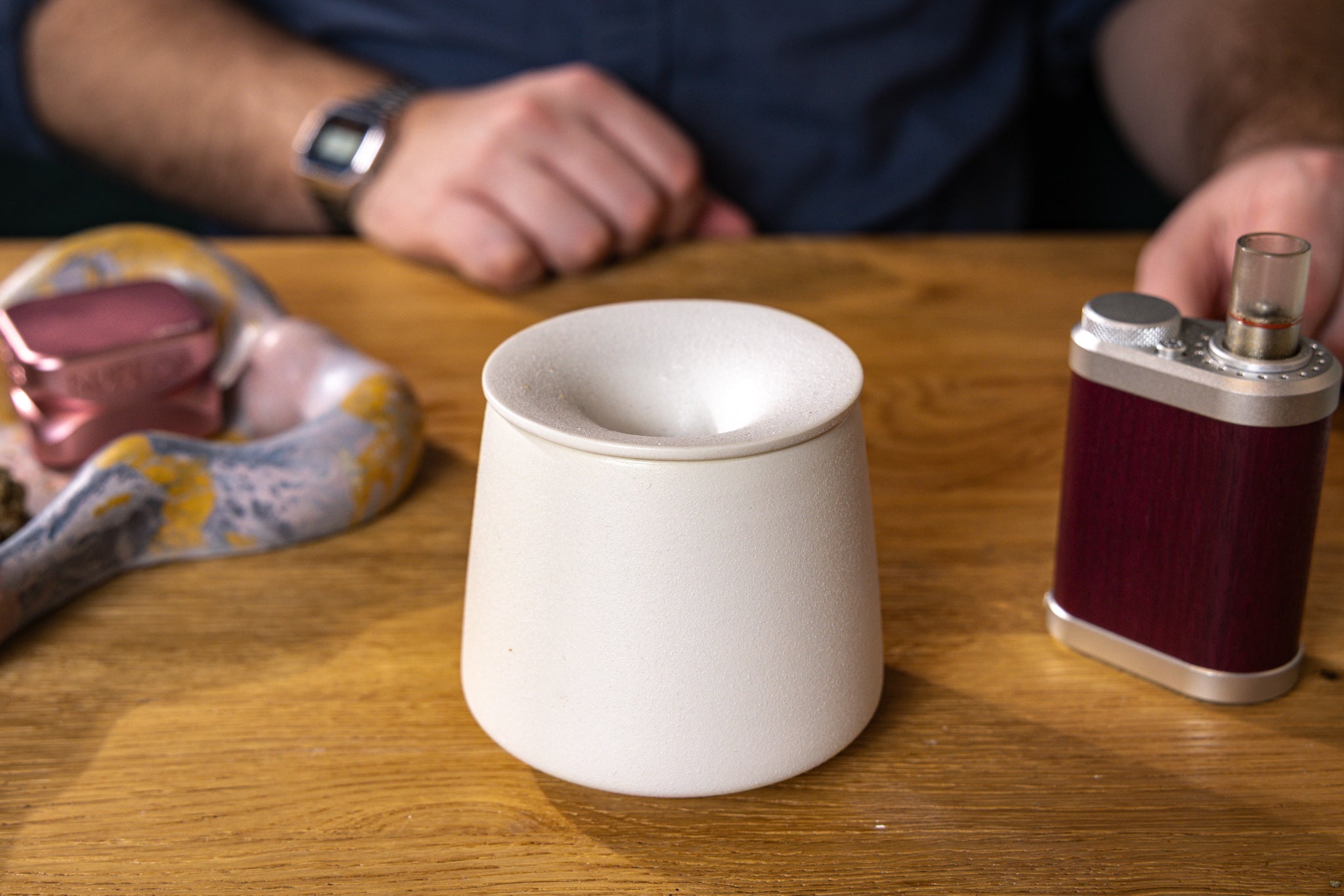 white Ceramic AVB ashtray being used to empty dry herb vape chamber